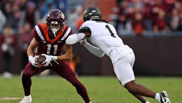 Oct 14, 2023; Blacksburg, Virginia, USA; Virginia Tech Hokies wide receiver Tucker Holloway (11) catches a pass against Wake Forest Demon Deacons defensive back Caelen Carson (1) during the fourth quarter at Lane Stadium.